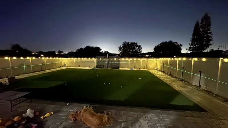Patio and putting green lit at dusk